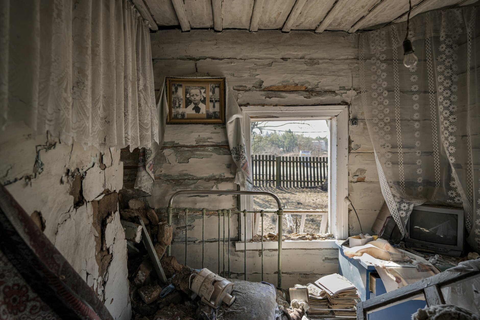 A photograph hangs on a wall inside a house destroyed by fighting between Russian and Ukrainian forces in the village of Yasnohorodka, on the outskirts of Kyiv, Ukraine, Friday, March 25, 2022. With stunning speed, Russia's war in Ukraine is driving Western Europe into the outstretched arms of the United States again, and the embrace was especially apparent when President Joe Biden offered a major expansion of natural gas shipments to his European Union counterpart Friday. (AP Photo/Vadim Ghirda)