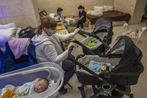 Surrogate babies born in Ukraine wait out war in basement