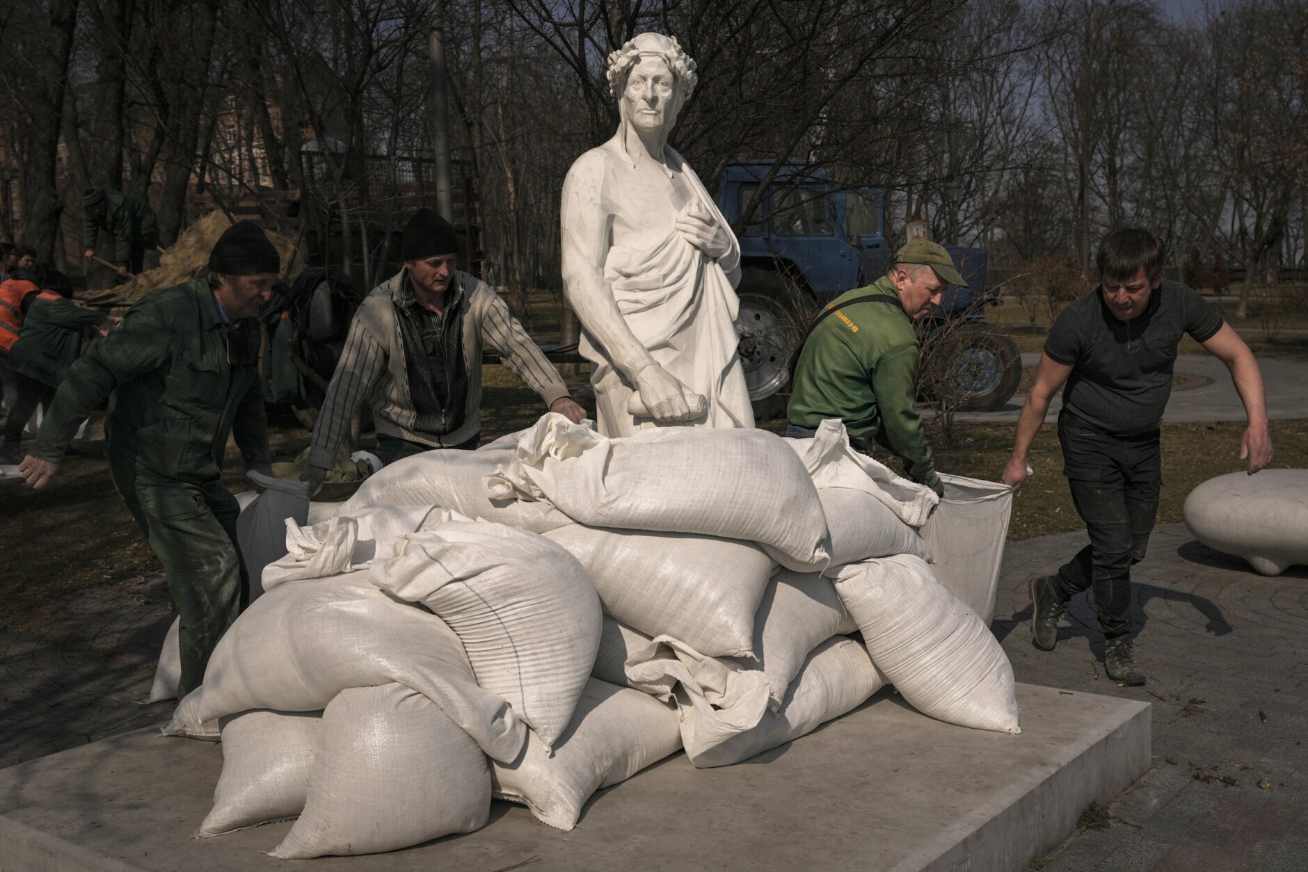 Municipal workers cover the statue of Italian poet and philosopher Dante Alighieri with sandbags to protect it from potential damage from shelling, in Kyiv, Ukraine, Wednesday, March 23, 2022. The statue, by sculptor Luciano Massari, was inaugurated in 2015 to mark 750 years since Dante's birth. (AP Photo/Vadim Ghirda)