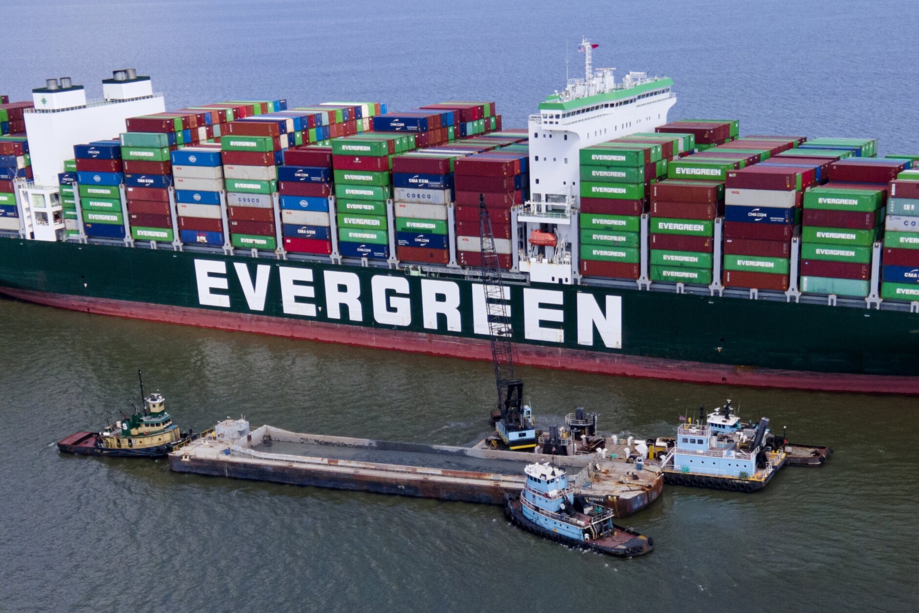 Crews are dredging near the container ship Ever Forward to extricate it after it ran aground off the coast near Pasadena, Maryland Monday, March 21, 2022.  The ship is not blocking navigation in the canal, unlike last year's high-profile ship's sister ship Ever Given ran aground in the Suez Canal, disrupting the global <a class=