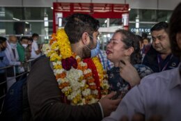 An Indian student studying in Ukraine who was evacuated from Sumy meets his family upon arrival at Indira Gandhi International Airport in New Delhi, India, Friday, March 11, 2022. Hundreds of Indian medical students stuck in bunkers in one of the worst-hit north-eastern Ukrainian city of Sumy returned home Friday. (AP Photo/Altaf Qadri)