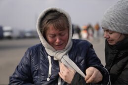 A woman fleeing from Ukraine is overcome by emotions at the border crossing in Medyka, Poland, Friday, March 4, 2022. More than 1 million people have fled Ukraine following Russia's invasion in the swiftest refugee exodus in this century, the United Nations said Thursday. (AP Photo/Markus Schreiber)