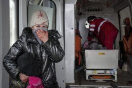 A woman reacts as paramedics perform CPR on a girl who was injured during shelling, at city hospital of Mariupol, eastern Ukraine, Sunday, Feb. 27, 2022. The girl did not survive. (AP Photo/Evgeniy Maloletka)