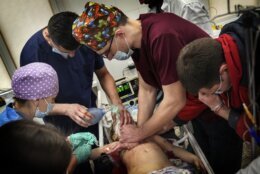 Medics perform CPR on a girl at the city hospital of Mariupol, who was injured during shelling in a residential area in eastern Ukraine, Sunday, Feb. 27, 2022. The girl did not survive. (AP Photo/Evgeniy Maloletka)