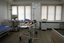 The lifeless body of a girl killed during the shelling of a residential area lies on a medical cart at the city hospital of Mariupol, eastern Ukraine, Sunday, Feb. 27, 2022. (AP Photo/Evgeniy Maloletka)