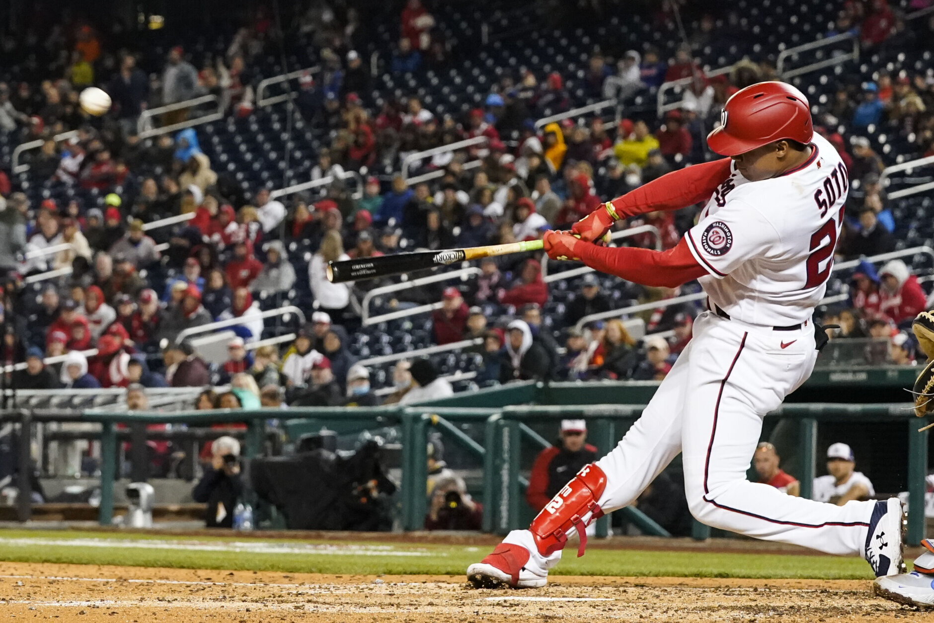 Washington Nationals' Juan Soto connects for a solo home run off New York Mets relief pitcher Trevor May during the sixth inning of an opening day baseball game at Nationals Park, Thursday, April 7, 2022, in Washington. (AP Photo/Alex Brandon)