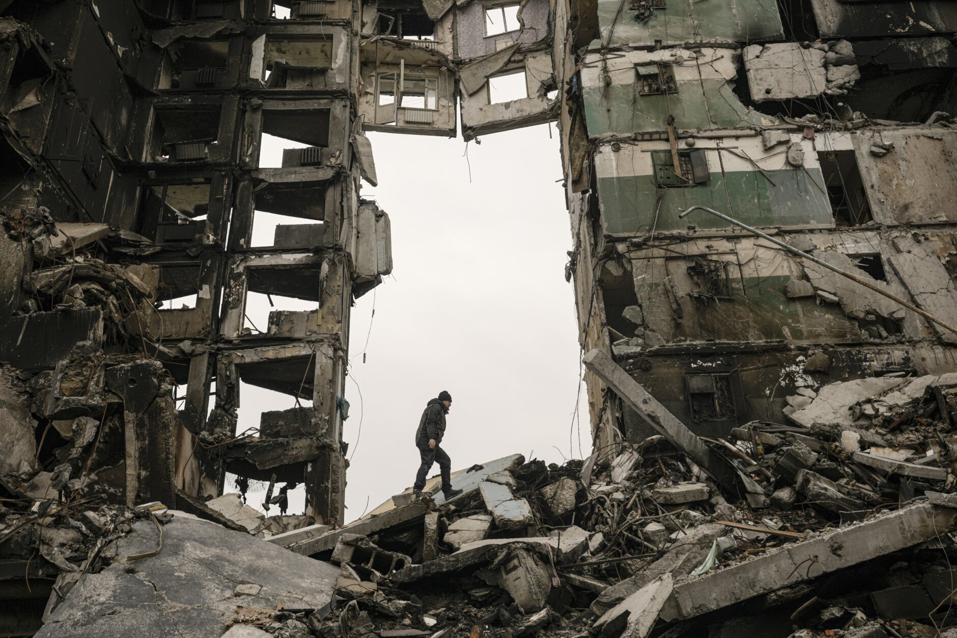 A resident looks for belongings in an apartment building destroyed during fighting between Ukrainian and Russian forces in Borodyanka, Ukraine, Tuesday, April 5, 2022. Ukrainian President Volodymyr Zelenskyy accused Russian troops of gruesome atrocities in Ukraine and told the U.N. Security Council on Tuesday that those responsible should immediately be brought up on war crimes charges in front of a tribunal like the one set up at Nuremberg after World War II.(AP Photo/Vadim Ghirda)