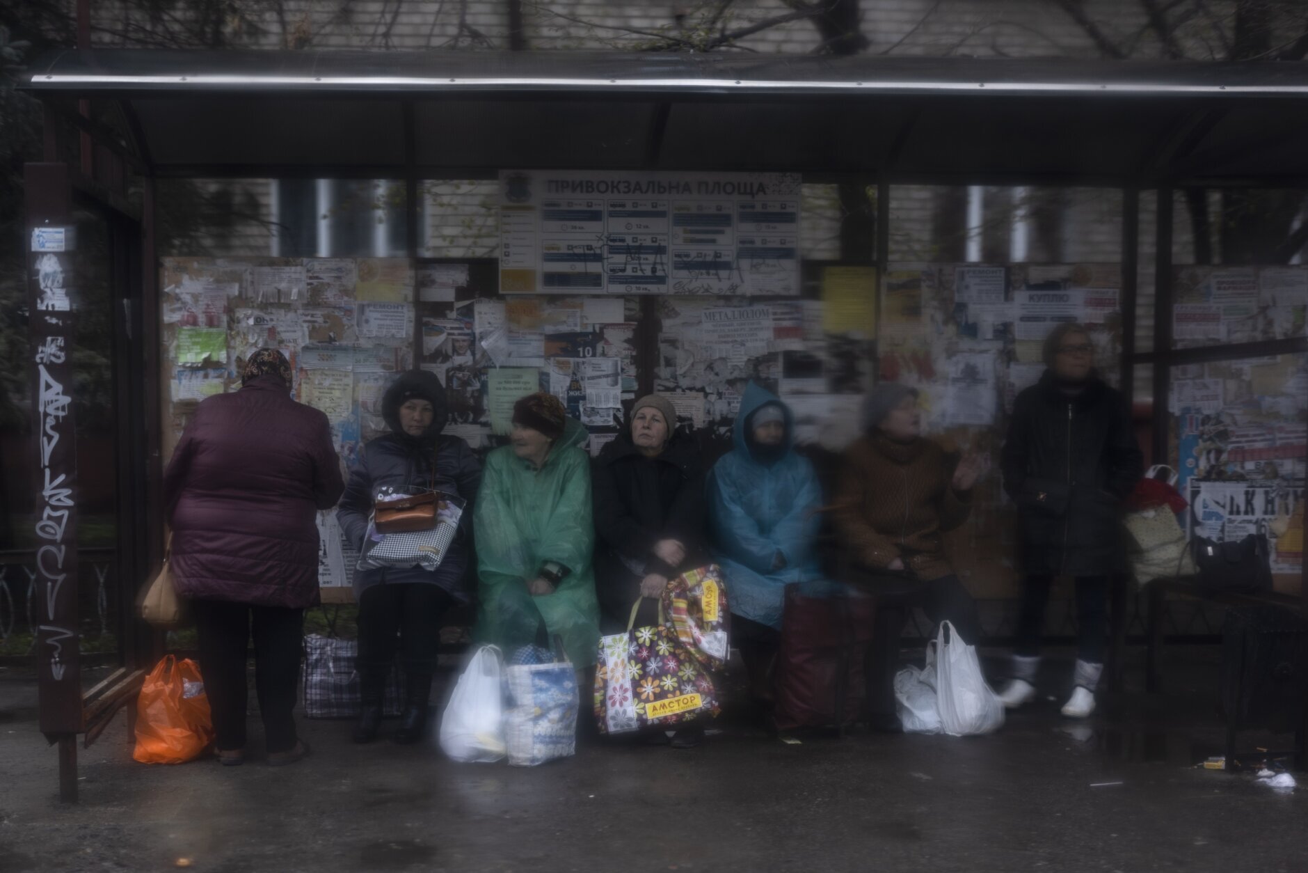 Women wait at a bus station in Kramatorsk, Ukraine, Thursday, April 14, 2022. (AP Photo/Petros Giannakouris)