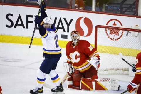 Walker breaks tie late in 3rd, Blues beat Flames 6-4