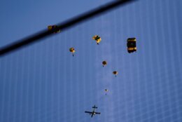 The U.S. Army Parachute Team the Golden Knights jump out of their aircraft before a baseball game between the Washington Nationals and the Arizona Diamondbacks at Nationals Park, Wednesday, April 20, 2022, in Washington. The U.S. Capitol was briefly evacuated after police said they were tracking an aircraft “that poses a probable threat,” but the plane turned out to be the military aircraft with people parachuting out of it for a demonstration at the Nationals game, officials told The Associated Press. (AP Photo/Alex Brandon)