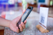 Close-up of a hand holding phone and scanning QR code