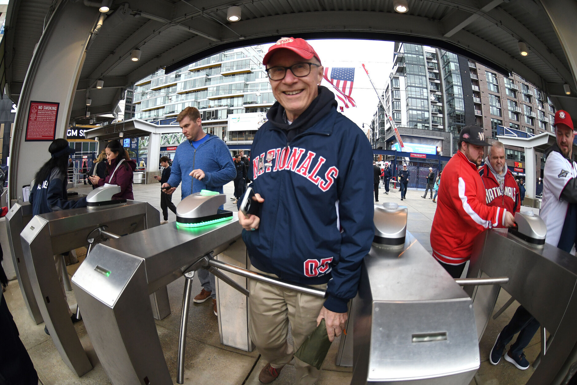 WASHINGTON, DC - APRIL 07:  A Washington Nationals fan enters the ballpark before the game against the New York Mets on Opening Day at the Nationals Park on April 7, 2022 in Washington, DC.  (Photo by Mitchell Layton/Getty Images)