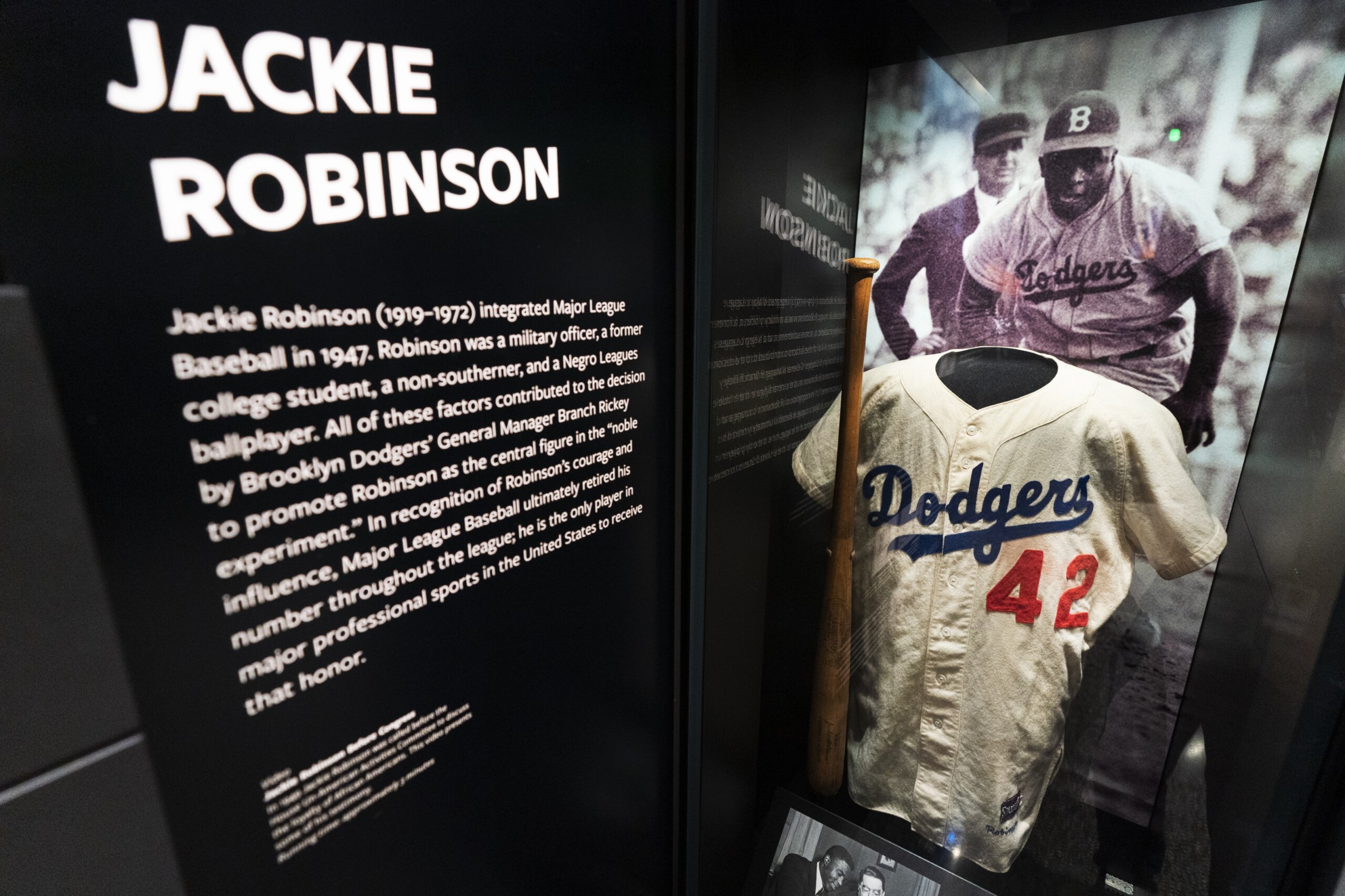 A fan puts on a give-away Jackie Robinson jersey with No. 42 on