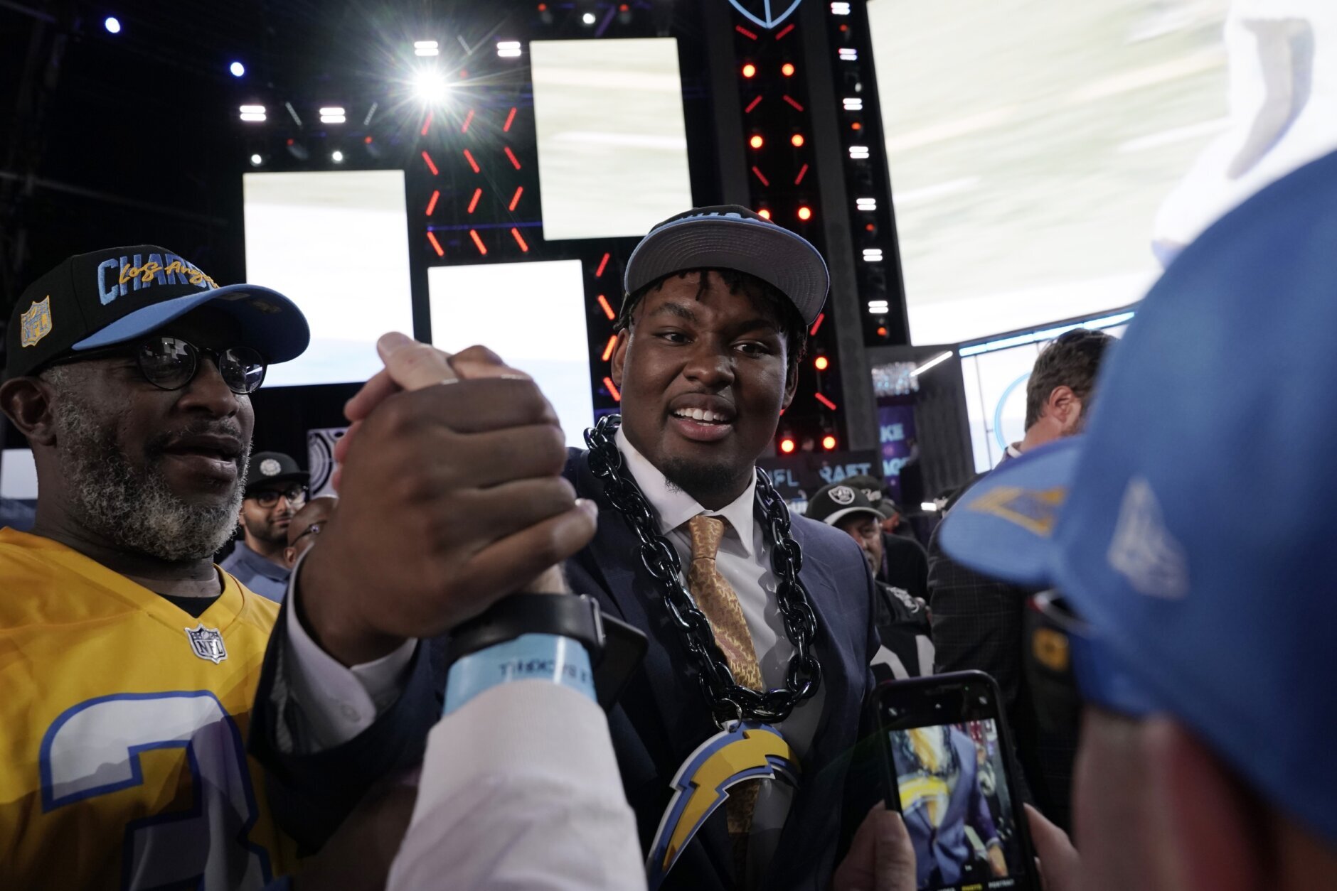 Boston College offensive lineman Zion Johnson shakes hands with fans after being chosen by the Los Angeles Chargers with the 17th pick of the NFL football draft Thursday, April 28, 2022, in Las Vegas. (AP Photo/Jae C. Hong)