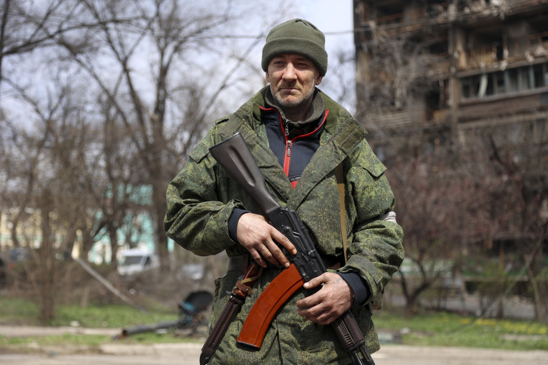 An armed serviceman of Donetsk People's Republic militia patrols a street in an area controlled by Russian-backed separatist forces in Mariupol, Ukraine, Friday, April 15, 2022. Mariupol, a strategic port on the Sea of Azov, has been besieged by Russian troops and forces from self-proclaimed separatist areas in eastern Ukraine for more than six weeks. (AP Photo/Alexei Alexandrov)