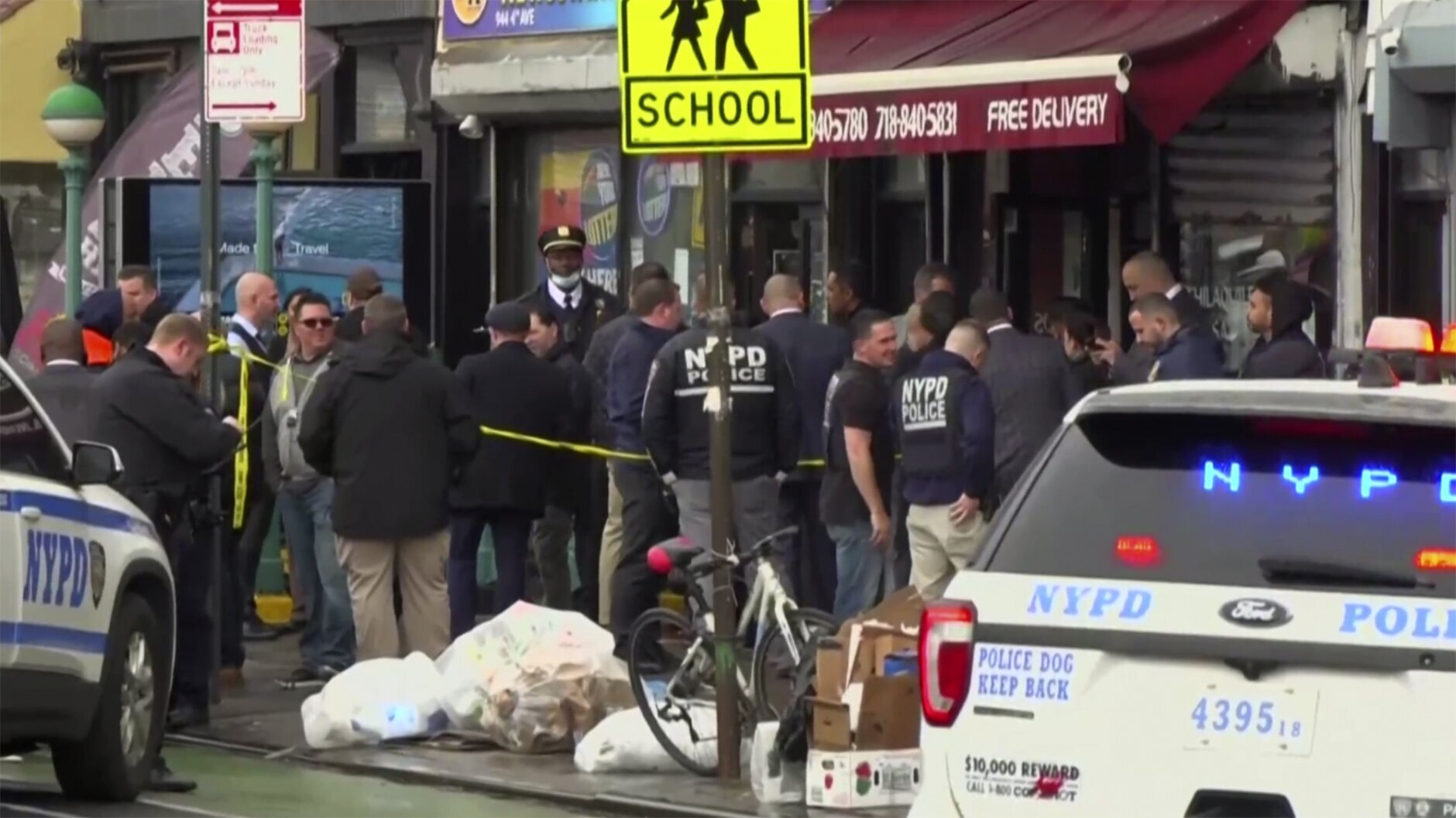 This still image provided by WABC shows law enforcement gathering at the scene of a shooting in the Brooklyn borough of New York on Tuesday, April 12, 2022.  Law enforcement sources say five people were shot  at a subway station in Brooklyn . Fire personnel responding to reports of smoke Tuesday morning at the 36th Street station in Sunset Park found multiple people shot and unexploded devices. (WABC via AP)