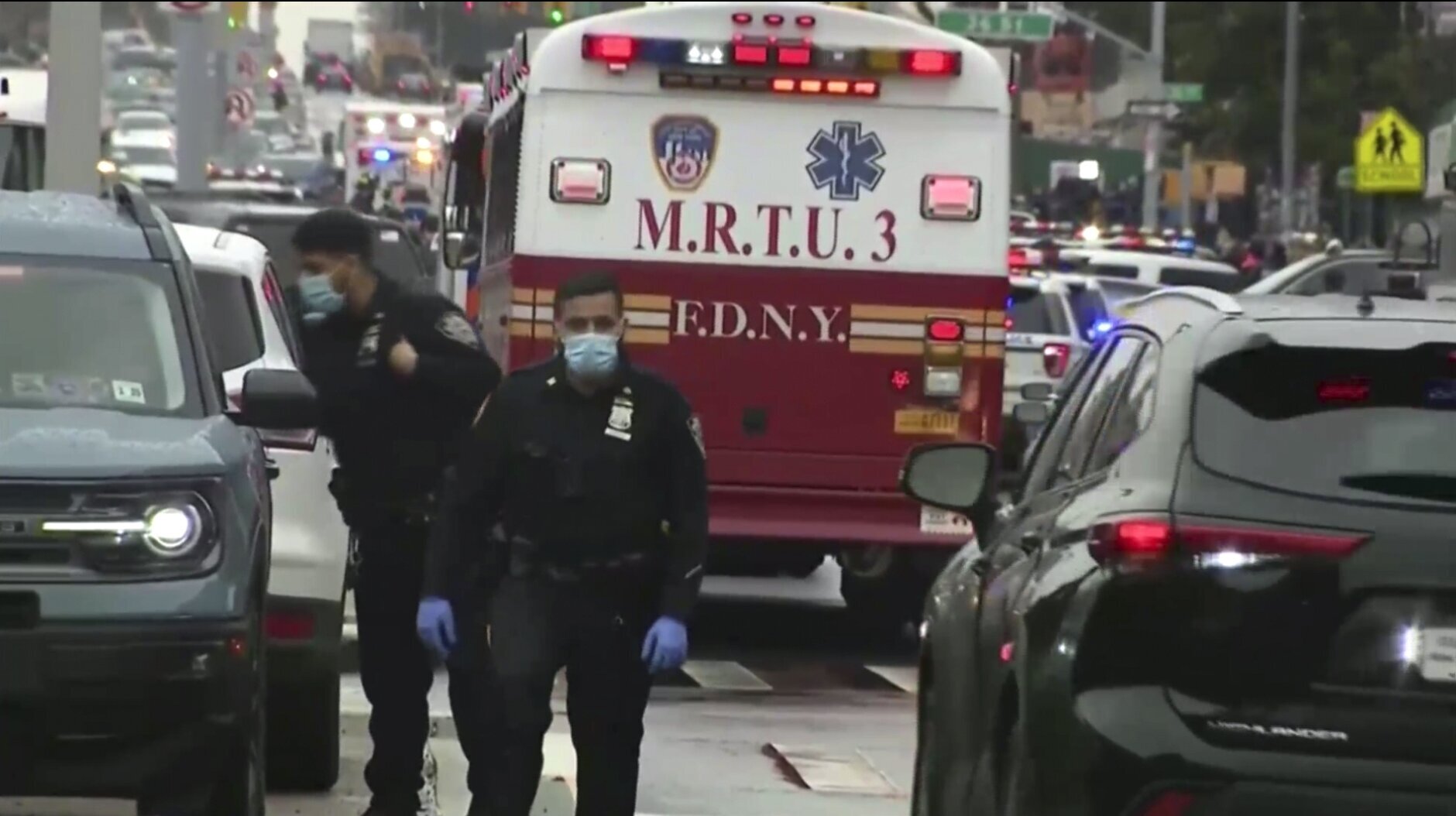 This still image provided by WABC shows law enforcement gathering at the scene of a shooting in the Brooklyn borough of New York on Tuesday, April 12, 2022.  Law enforcement sources say five people were shot  at a subway station in Brooklyn . Fire personnel responding to reports of smoke Tuesday morning at the 36th Street station in Sunset Park found multiple people shot and unexploded devices. (WABC via AP)