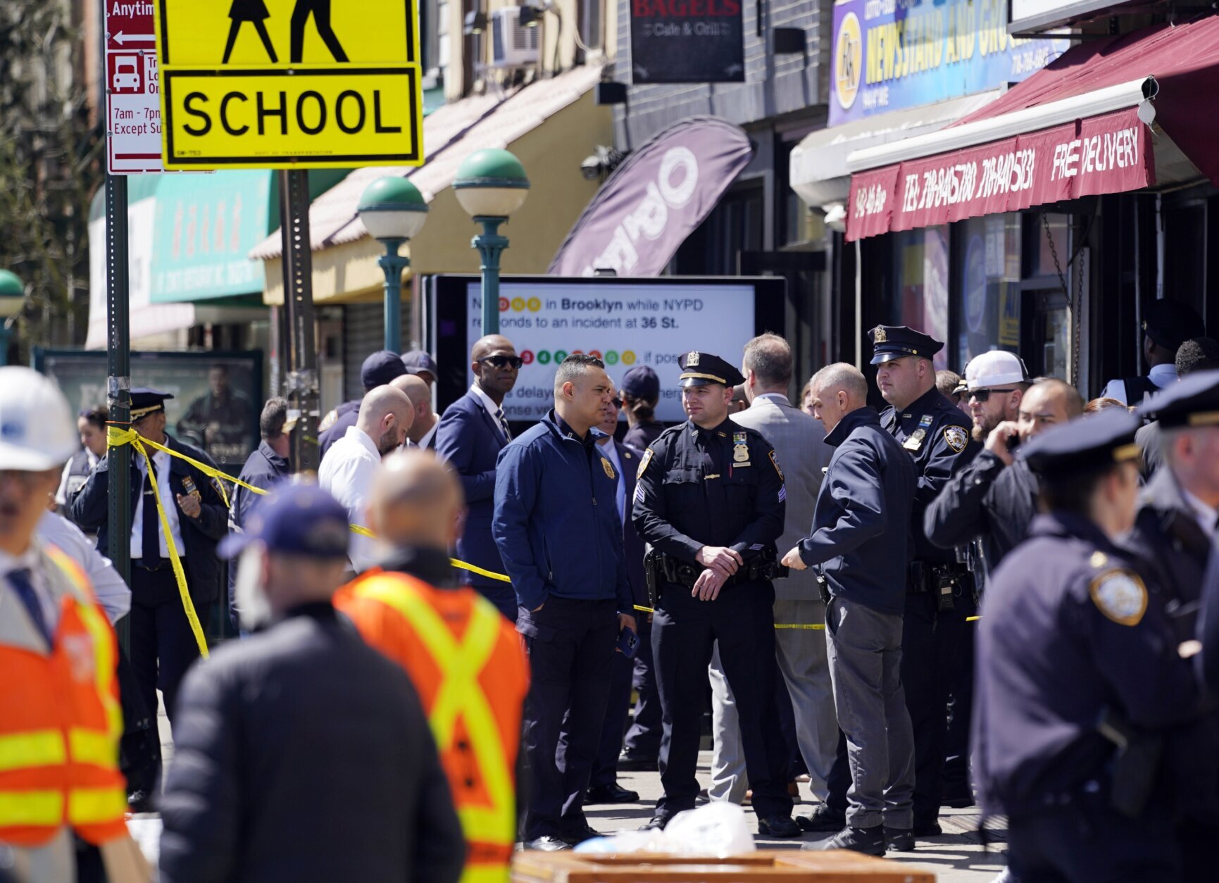 Emergency personnel gather at the entrance to a subway station in the Brooklyn borough of New York, Tuesday, April 12, 2022. Multiple people were shot Tuesday morning at a subway station in Brooklyn, law enforcement sources said. (AP Photo/John Minchillo)