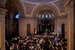 Hundreds of people light candles at the beginning of the Easter Vigil Mass at the Cathedral of St. Paul in St. Paul, Minn., on Saturday, April 16, 2022. For many U.S. Christians, this weekend marks the first time since 2019 that they will gather in person on Easter Sunday, a welcome chance to celebrate one of the year's holiest days side by side with fellow congregants. (AP Photo/Giovanna Dell'Orto)