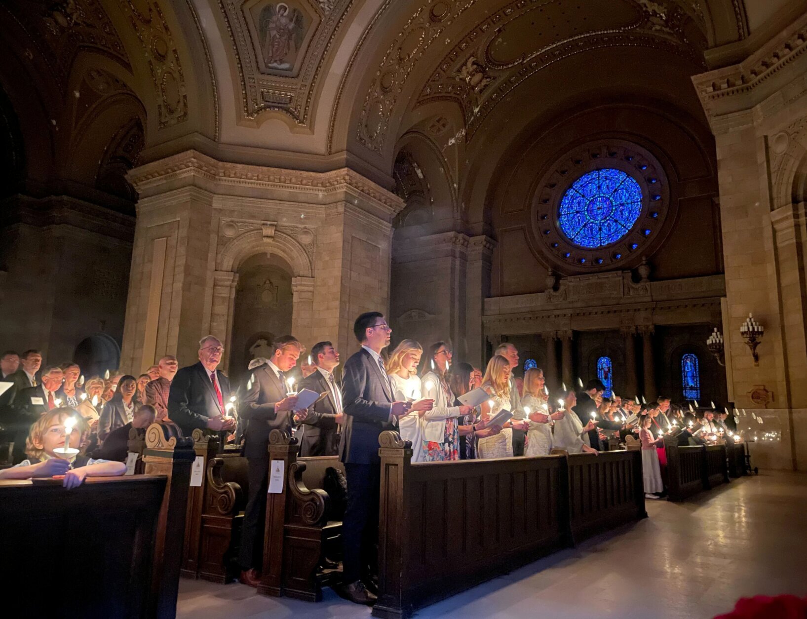 Hundreds of people light candles at the beginning of the Easter Vigil Mass at the Cathedral of St. Paul in St. Paul, Minn., on Saturday, April 16, 2022. For many U.S. Christians, this weekend marks the first time since 2019 that they will gather in person on Easter Sunday, a welcome chance to celebrate one of the year's holiest days side by side with fellow congregants.  (AP Photo/Giovanna Dell'Orto)