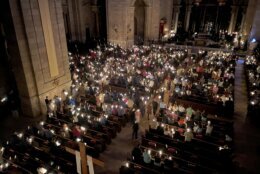 Hundreds of people light candles at the beginning of the Easter Vigil Mass at the Cathedral of St. Paul in St. Paul, Minn., on Saturday, April 16, 2022. For many U.S. Christians, this weekend marks the first time since 2019 that they will gather in person on Easter Sunday, a welcome chance to celebrate one of the year's holiest days side by side with fellow congregants. (AP Photo/Giovanna Dell'Orto)