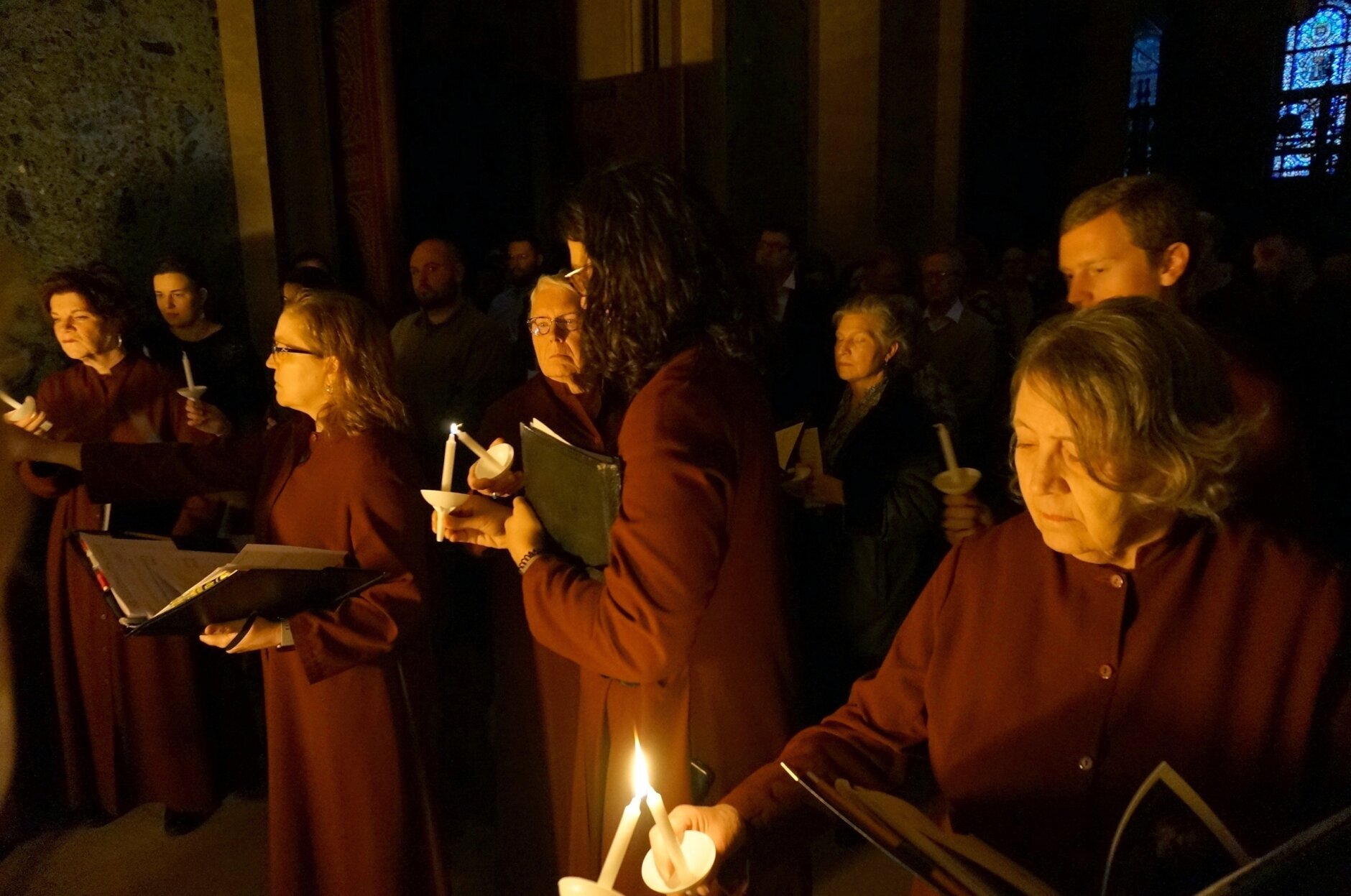 Members of the choir light candles at the beginning of the Easter Vigil Mass at the Cathedral of St. Paul in St. Paul, Minn.,, on Saturday, April 16, 2022. For many U.S. Christians, this weekend marks the first time since 2019 that they will gather in person on Easter Sunday, a welcome chance to celebrate one of the year's holiest days side by side with fellow congregants.  (AP Photo/Giovanna Dell'Orto)
