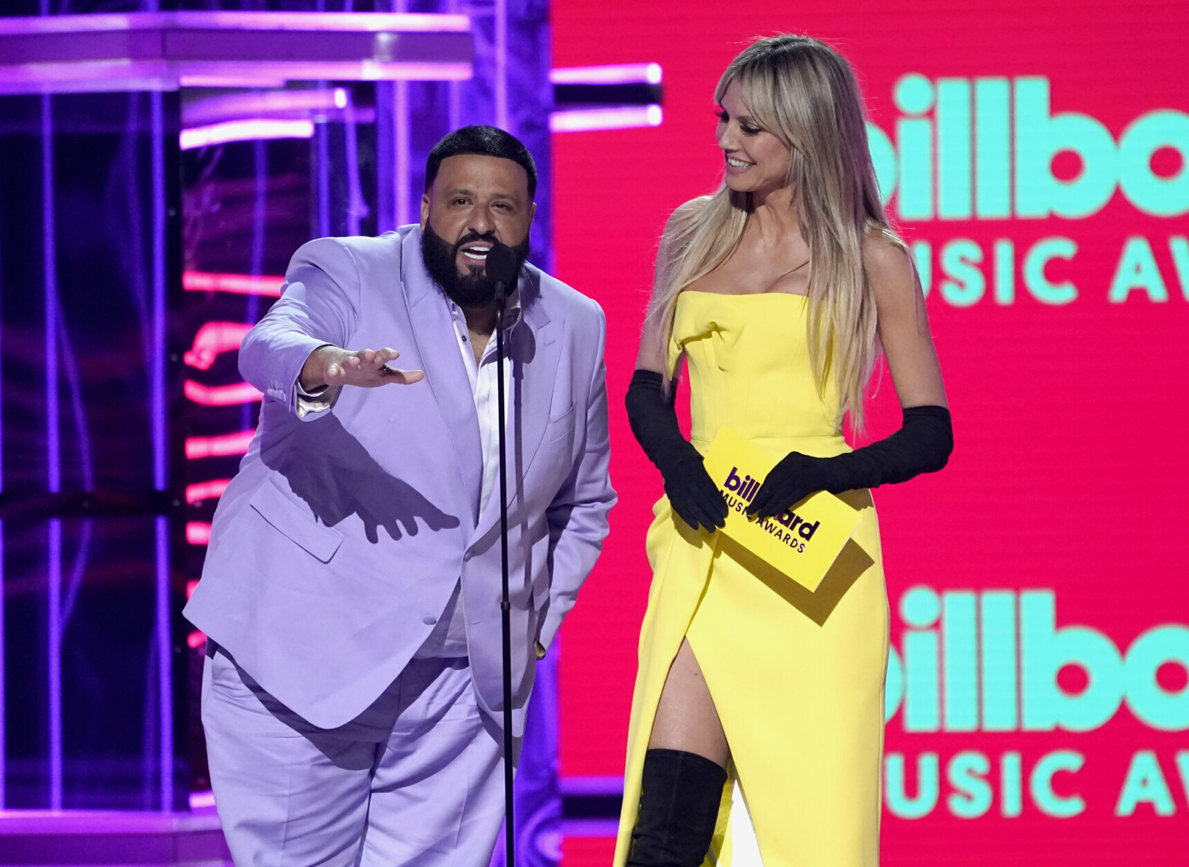 DJ Khaled, left, and Heidi Klum present the award for top rock artist at the Billboard Music Awards on Sunday, May 15, 2022, at the MGM Grand Garden Arena in Las Vegas. (AP Photo/Chris Pizzello)