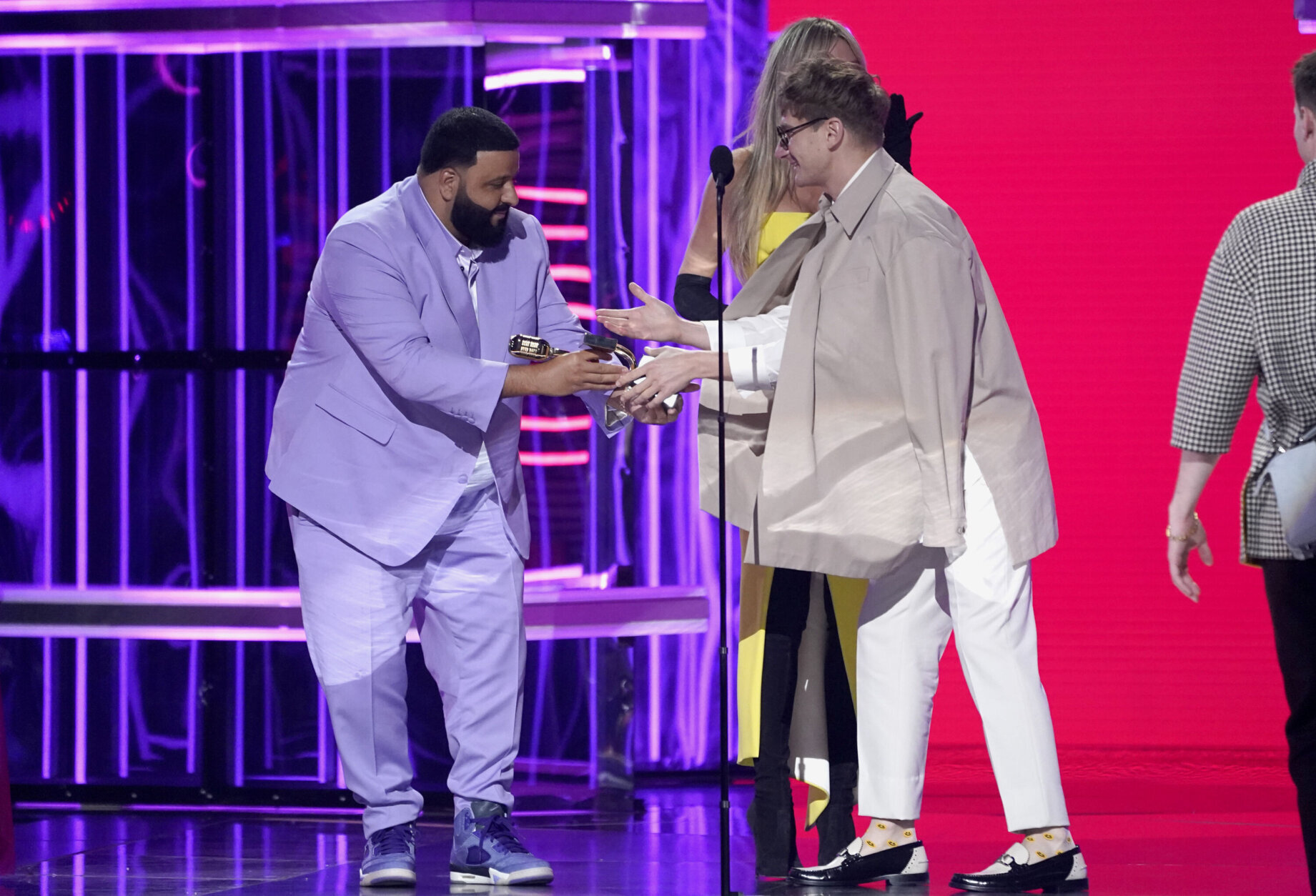 DJ Khaled, left, presents Dave Bayley of Glass Animals with the award for top rock artist at the Billboard Music Awards on Sunday, May 15, 2022, at the MGM Grand Garden Arena in Las Vegas. (AP Photo/Chris Pizzello)