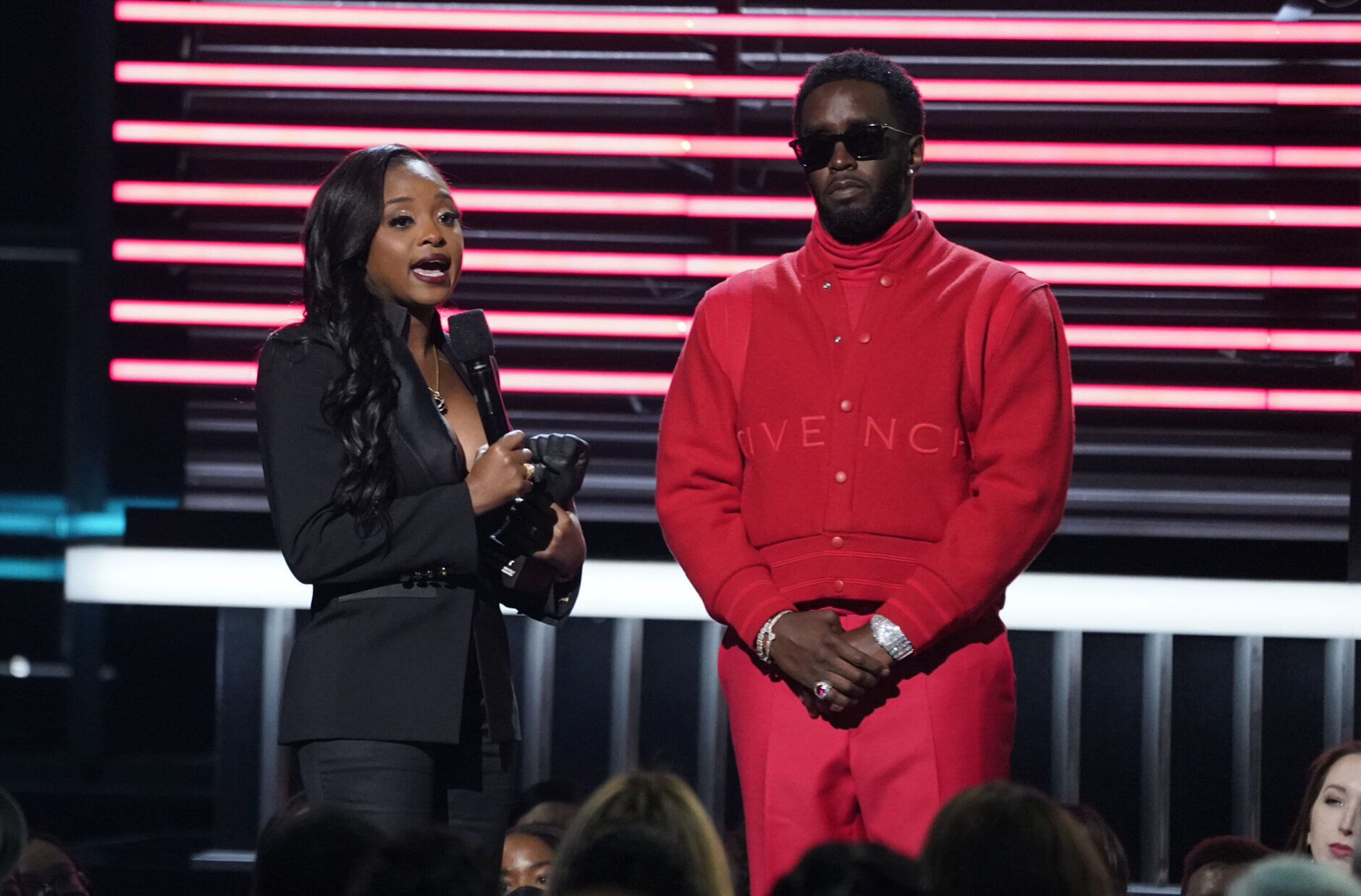 Sean "Diddy" Combs, right, presents the revolt black excellence award to social justice activist Tamika Mallory at the Billboard Music Awards on Sunday, May 15, 2022, at the MGM Grand Garden Arena in Las Vegas. (AP Photo/Chris Pizzello)