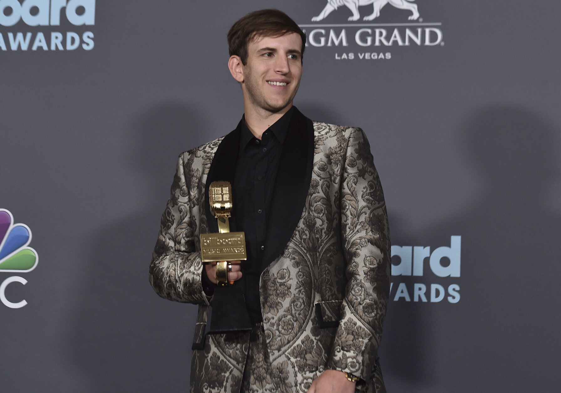 Illenium poses in the press room with the award for Top Dance/Electronic Album for "Fallen Embers" at the Billboard Music Awards on Sunday, May 15, 2022, at the MGM Grand Garden Arena in Las Vegas. (Photo by Jordan Strauss/Invision/AP)