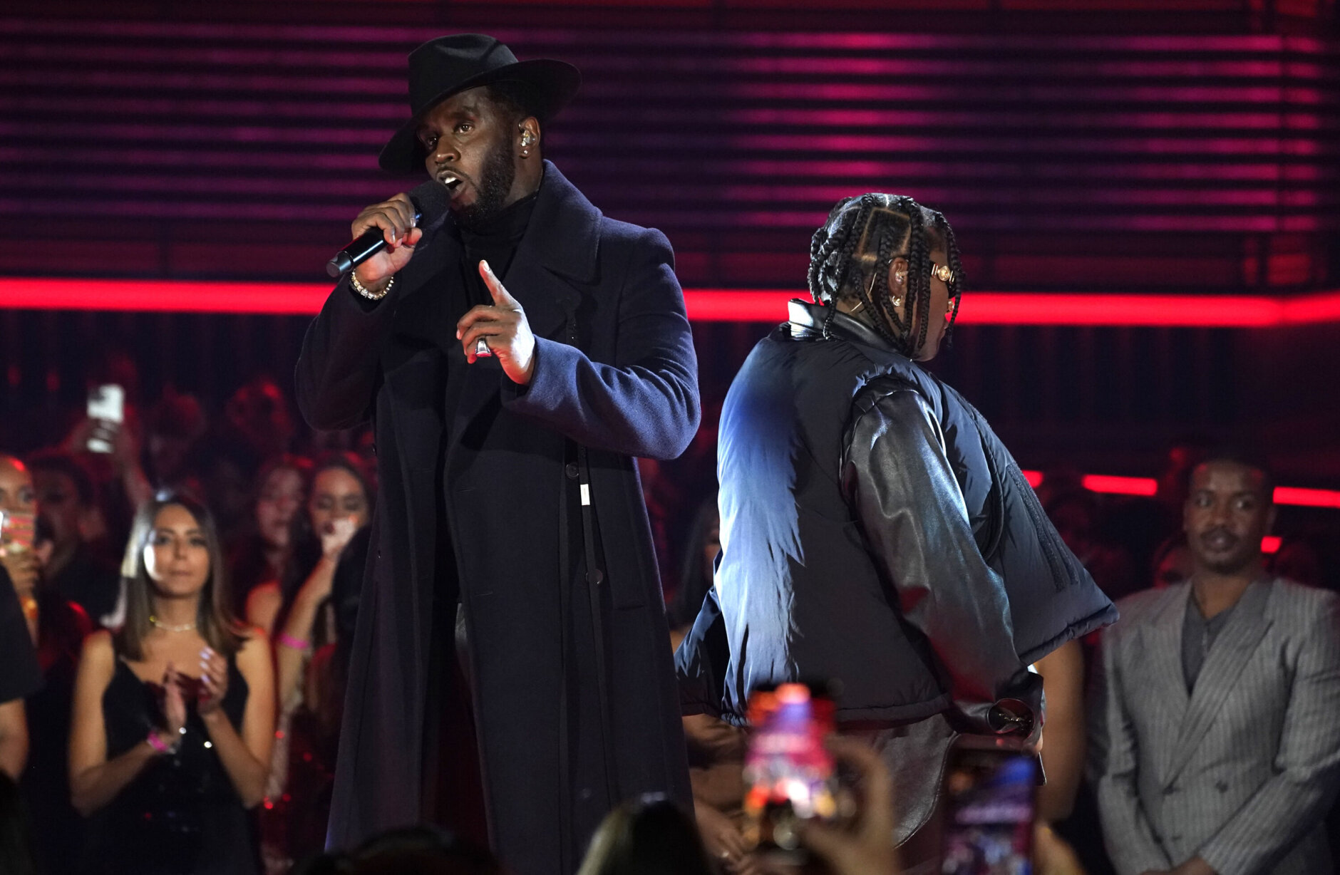 Sean "Diddy" Combs, left, and Jozzy speak onstage at the Billboard Music Awards on Sunday, May 15, 2022, at the MGM Grand Garden Arena in Las Vegas. (AP Photo/Chris Pizzello)