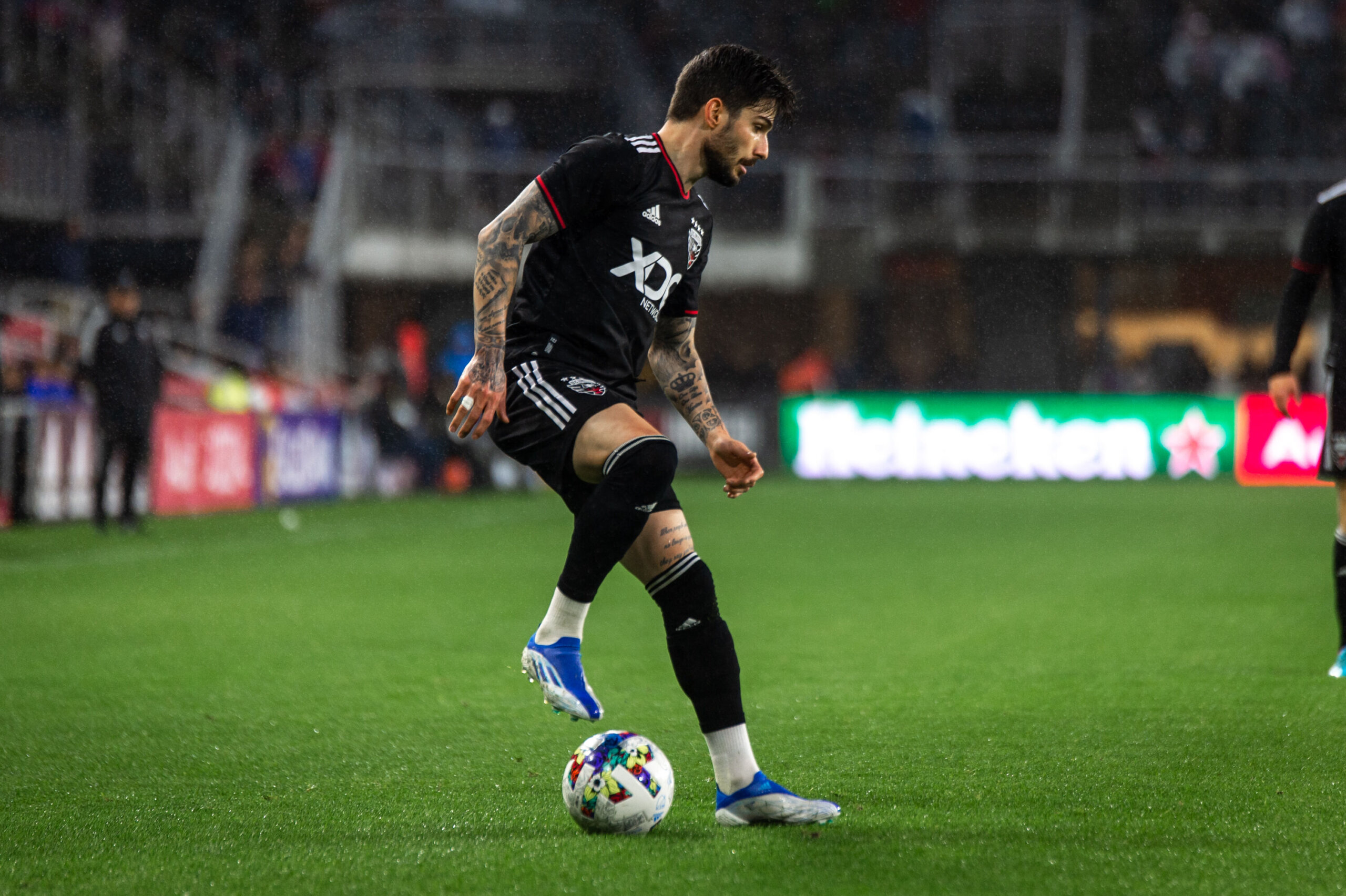 WASHINGTON, DC - MARCH 25: DC United midfielder Taxiarchis Taxi Fountas  (11) reacts while wearing the D.C. United Cherry Blossom Kit Jersey during  the New England Revolution versus D.C. United Major League