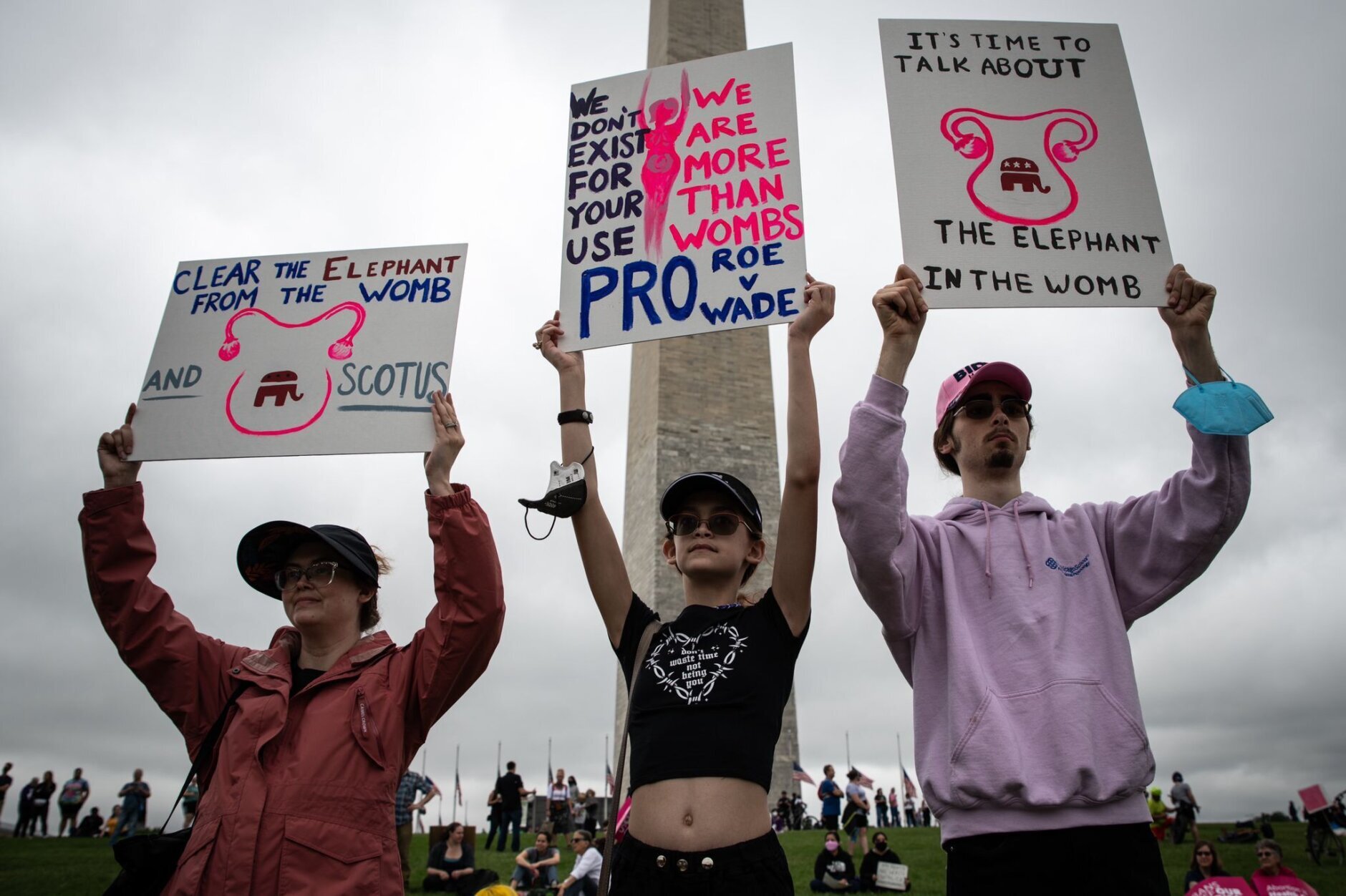 <p>Protestors gathered at the Washington Monument and then marched to the Supreme Court, with signs in hand. (WTOP/Alejandro Alvarez)</p>
