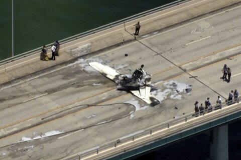 Small plane crashes on bridge near Miami, striking an SUV