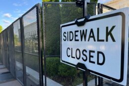 "Sidewalk closed" sign attached to fencing around the Supreme Court