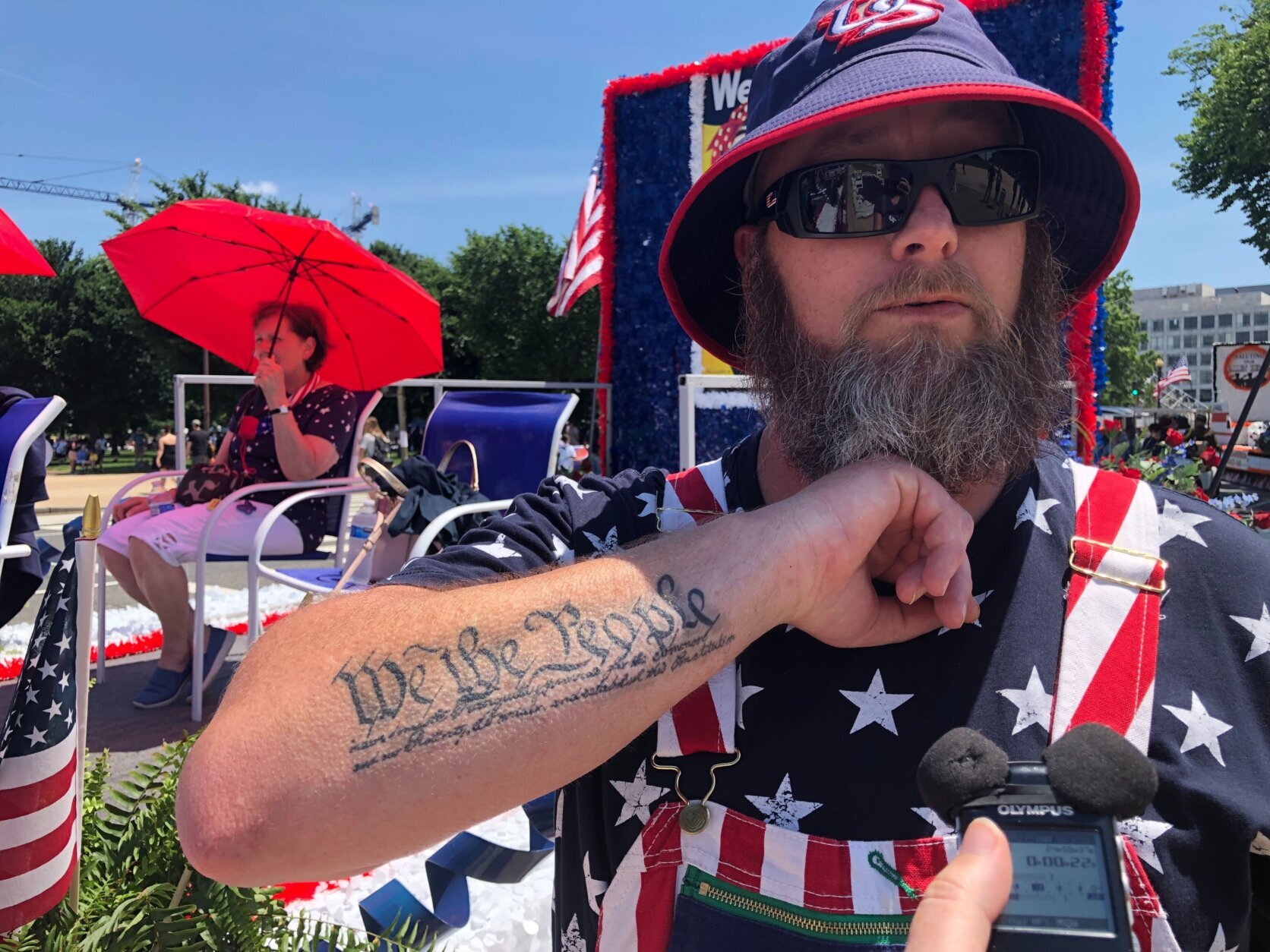Wesley Thomas of Maryland shows off one of his patriotic tattoos while watching Monday's parade. 