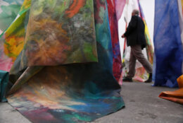 A man walks past an artwork by Sam Gilliam titled "untitled" on June 12, 2018 during the preview day of Art Basel, world's largest contemporary art fair in Basel which will take place between June 14 and 17, 2018. (Photo by SEBASTIEN BOZON / AFP) / RESTRICTED TO EDITORIAL USE - MANDATORY MENTION OF THE ARTIST UPON PUBLICATION - TO ILLUSTRATE THE EVENT AS SPECIFIED IN THE CAPTION        (Photo credit should read SEBASTIEN BOZON/AFP via Getty Images)