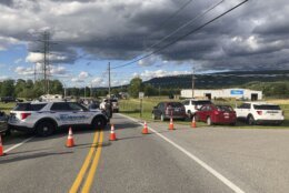 Law enforcement vehicles block the road at the scene of a shooting at a Maryland business near Smithsburg, Md., on Thursday June, 9 2022. A man opened fire at a manufacturing business in rural western Maryland on Thursday, killing multiple people before the suspect and a state trooper were wounded in a shootout, authorities said.(AP Photo/Michael Kunzelman)