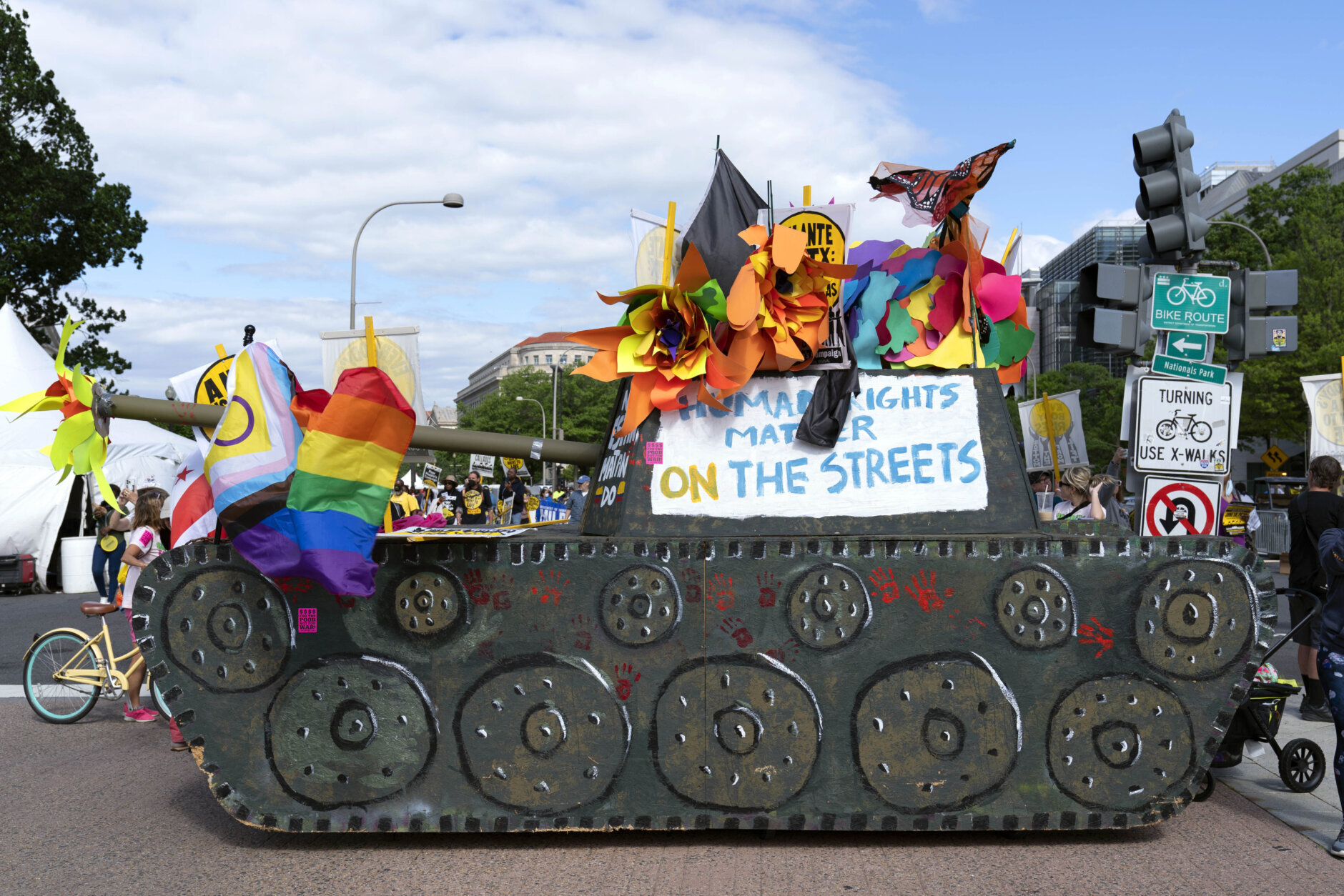 Demonstrators decorate a mock tank during the Poor People's Campaign, "Moral March" on Pennsylvania Avenue in Washington, Saturday, June 18, 2022. (AP Photo/Jose Luis Magana)
