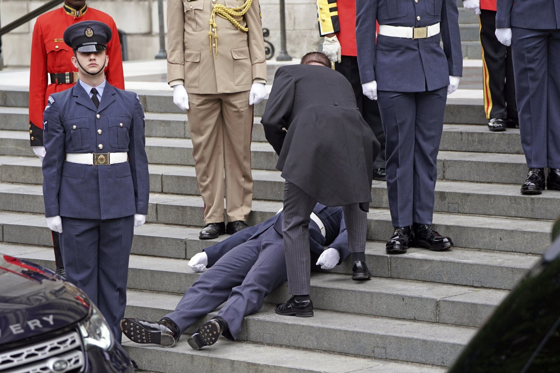 A Military personnel faints ahead of service of thanksgiving for the reign of Queen Elizabeth II at St Paul’s Cathedral in London, Friday June 3, 2022 on the second of four days of celebrations to mark the Platinum Jubilee. The events over a long holiday weekend in the U.K. are meant to celebrate the monarch’s 70 years of service. (Kirsty O'Connor, Pool Photo via AP)