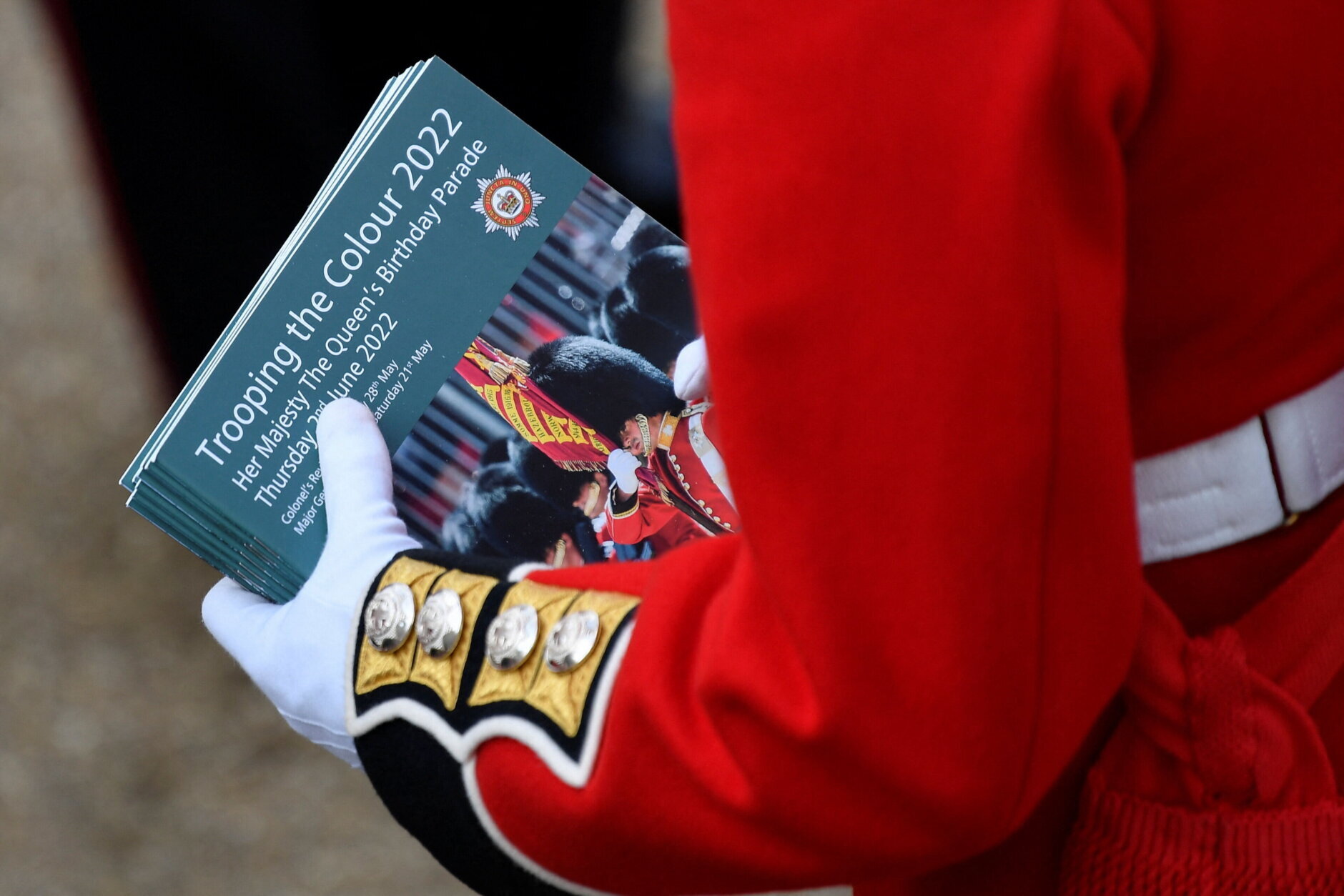 A member of the Coldstream Guards holds souvenir programs during Trooping The Colour on June 2, 2022 in London, England