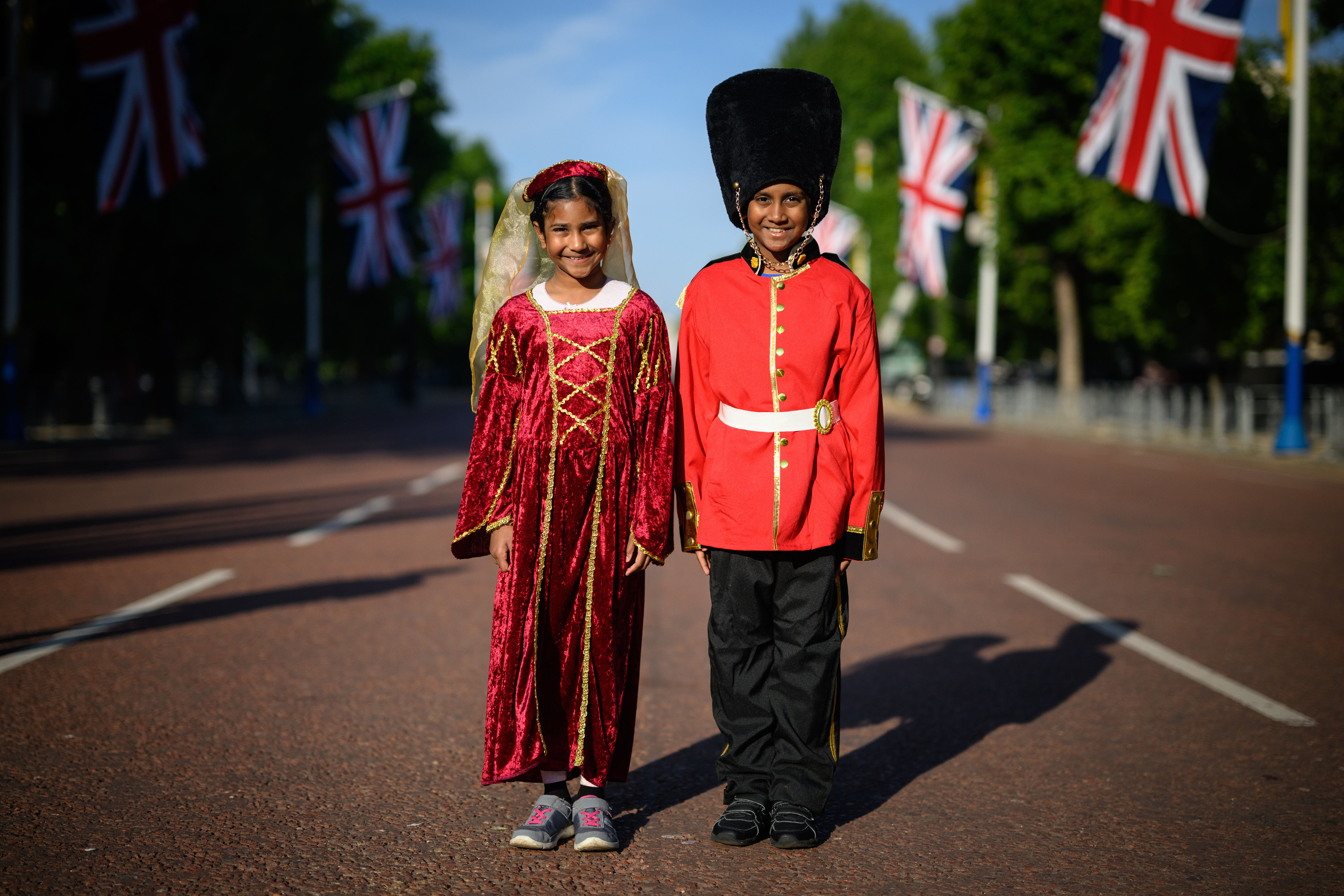 Pair of children wearing costumes as they arrive to celebrate the Platinum Jubilee of Queen Elizabeth II