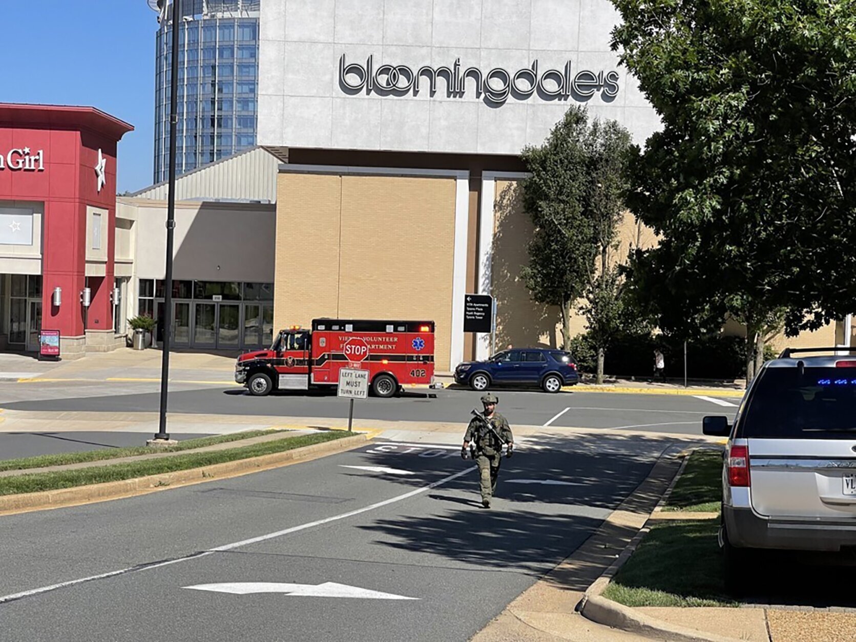 Law enforcement walks outside Tysons Corner Center mall in Tysons Corner, Va., Saturday, June 18, 2022. Authorities said a person fired a gun during a fight inside the mall. (Salwan Georges/The Washington Post via AP)