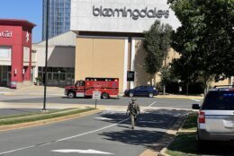 Law enforcement walks outside Tysons Corner Center mall in Tysons Corner, Va., Saturday, June 18, 2022. Authorities said a person fired a gun during a fight inside the mall. (Salwan Georges/The Washington Post via AP)
