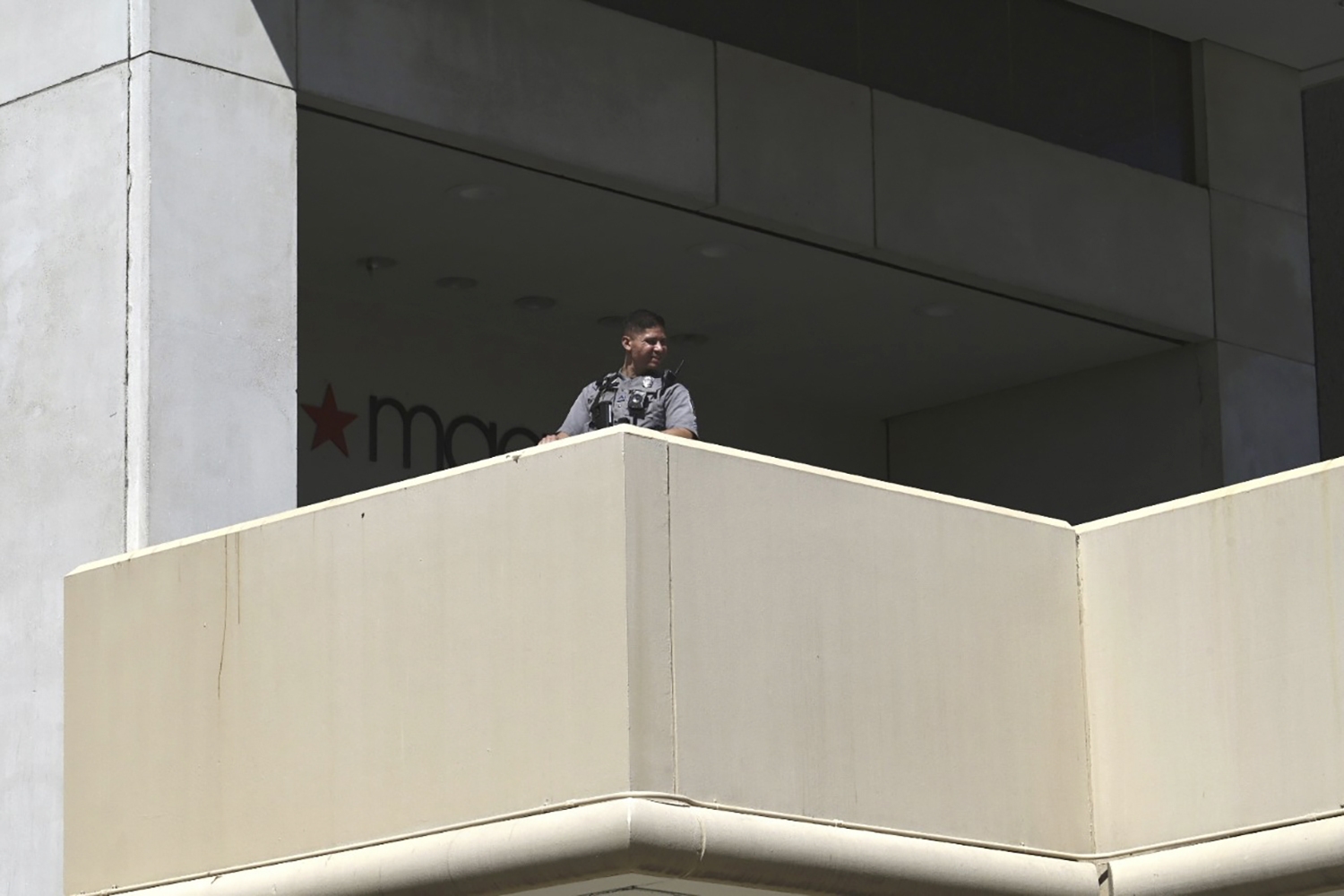 Police stand outside a Macys department store at Tysons Corner Mall in Tysons Corner, Va., on Saturday, June 18, 2022. A gun was fired when a fight broke out at the northern Virginia mall on Saturday, but no injuries were reported and there was no active shooter situation, police said. (Craig Hudson/The Washington Post via AP)