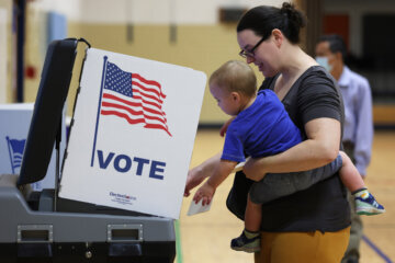 ALEXANDRIA, VIRGINIA - JUNE 21: A voter casts her ballot with her child at a polling station at Rose Hill Elementary School during the midterm primary election on June 21, 2022 in Alexandria, Virginia. In two of the most competitive districts in the U.S., Virginians will be choosing Republican nominees to take on Democratic incumbents Rep. Elaine Luria (D-VA) and Rep. Abigail Spanberger (D-VA). (Photo by Alex Wong/Getty Images)