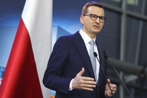 Polish leader faces questions about timing of bond purchase