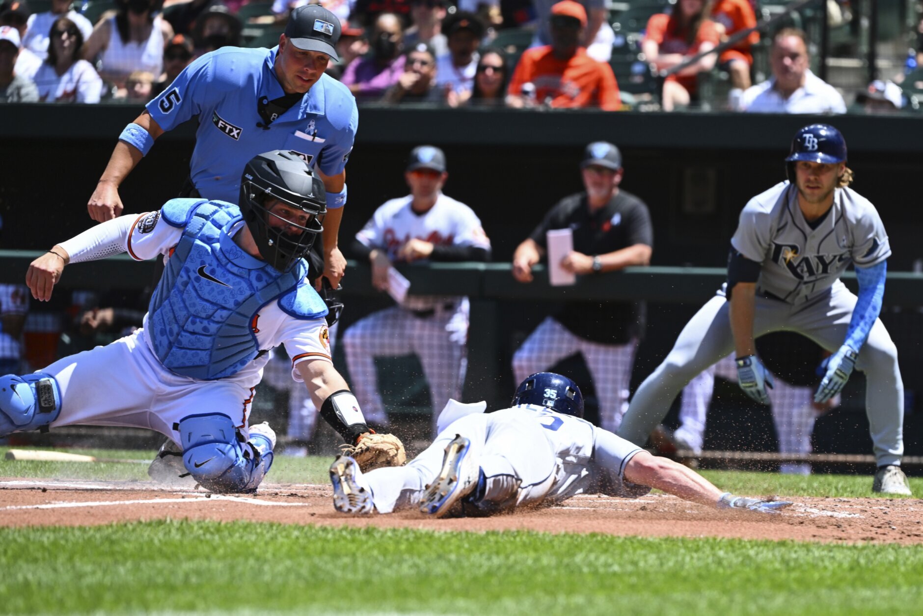 Tampa Bay Rays' Brett Phillips is greeted in the dugout after