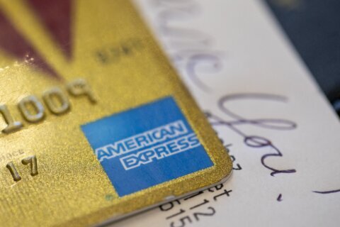 AmEx 2Q profits fall 14% despite higher cardmember spending