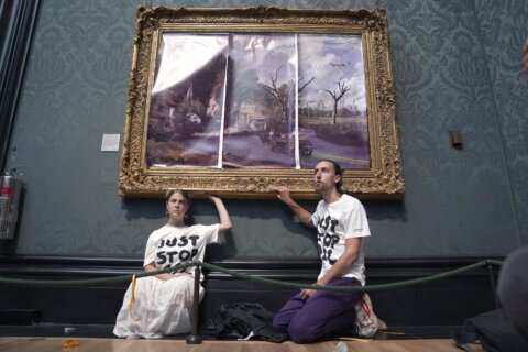 UK climate protesters glue themselves to gallery paintings